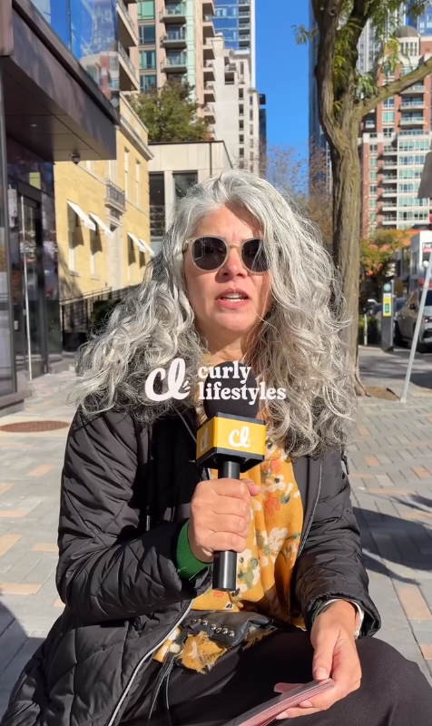 Elaine wearing her natural grey curls
