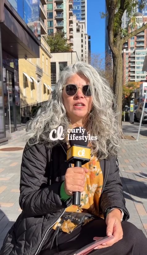 Elaine wearing her natural grey curls