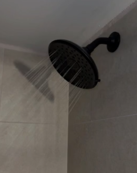 Shower head with the water running.