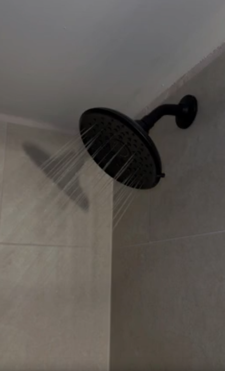 Shower head with the water running.