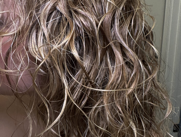 Close up of wet blonde curly hair.