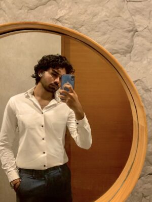 Man taking a mirror selfie.