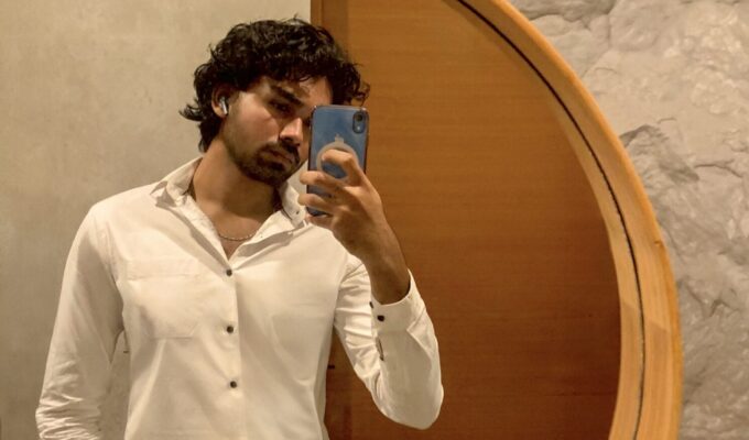 Man taking a mirror selfie.