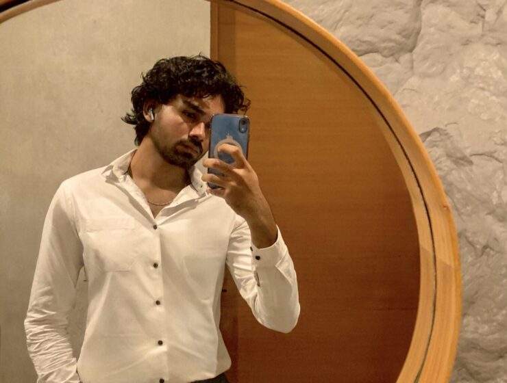 Man taking a mirror selfie.