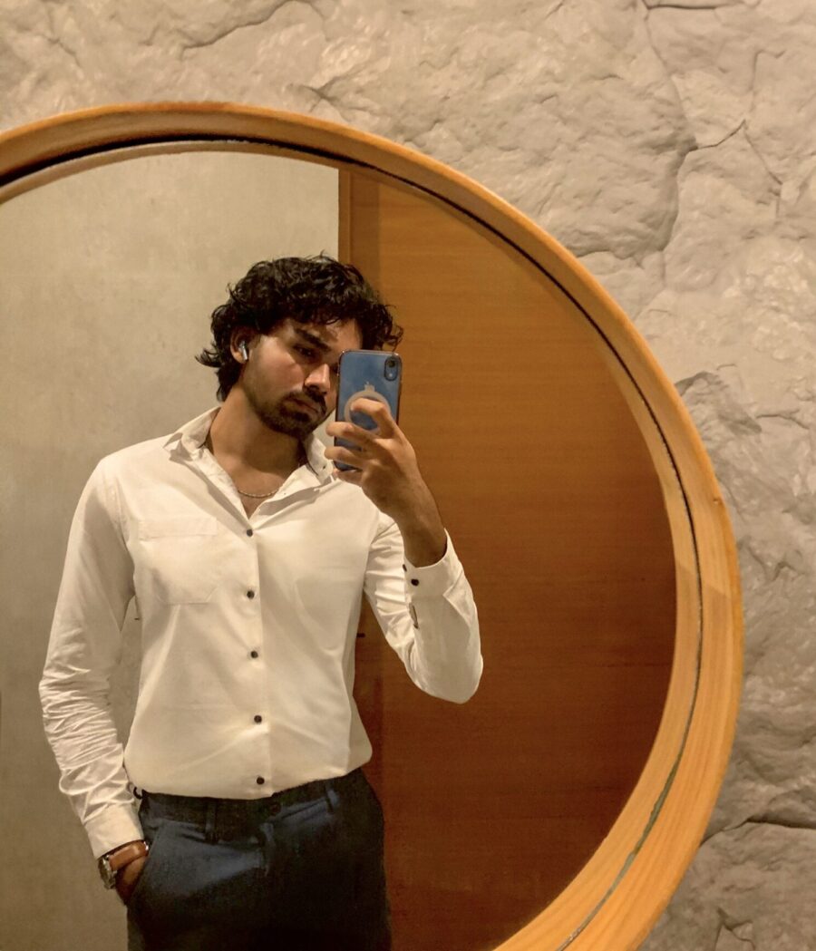 Man taking a mirror selfie.