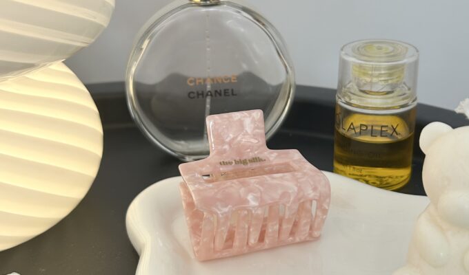 A dish of hair accessories and perfume.