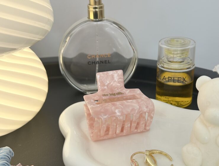 A dish of hair accessories and perfume.