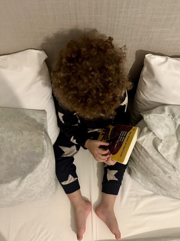 Top of the head of a child with curly hair.