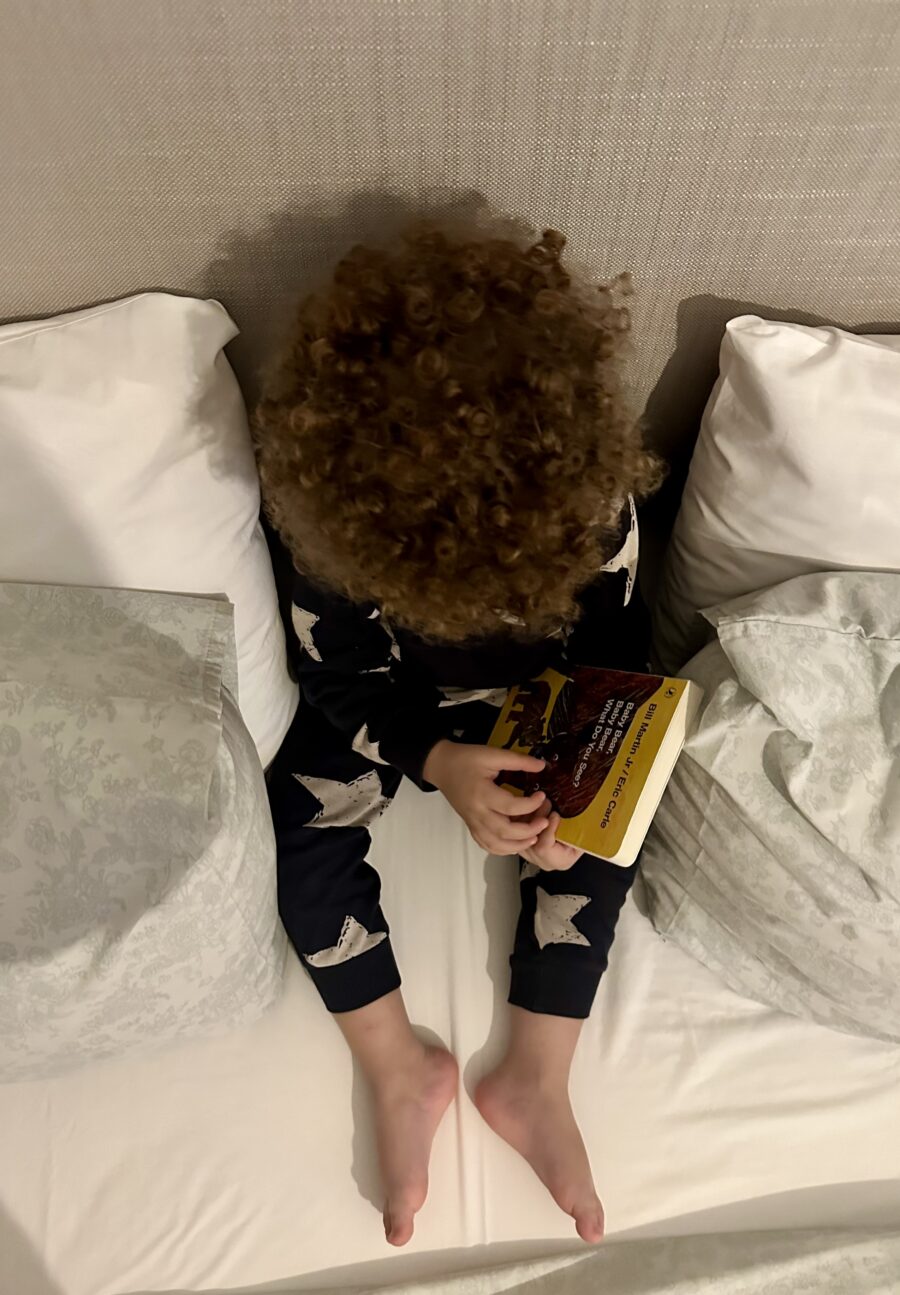 Top of the head of a child with curly hair.